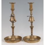 A pair of 18th century brass tavern or inn candlesticks, with fitted bells and circular dish