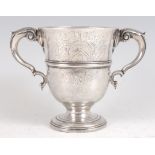A George II Irish silver loving cup, having acanthus leaf double flying C-scroll handles, engraved