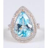 A yellow metal pear shaped blue topaz and diamond cluster ring, the blue topaz measuring approx 15.5