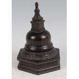 A 19th century lignum vitae table snuff box, having a finial topped bell cover to a hexagonal