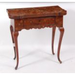 An 18th century continental walnut and marquetry inlaid card table, of small proportions, the shaped