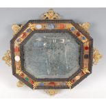 A 19th century mirror, in the Italian style, the octagonal bevelled plate within an ebonised