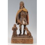 A circa 1700 South East Asian carved softwood and polychrome painted figure of St Roch, in