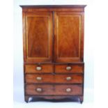 A Regency mahogany linenpress, having satinwood crossbanded panelled doors, enclosing fitted slides,