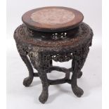 A late 19th century Chinese 'rosewood' and marble topped jardinière stand, of squat circular form,