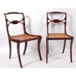 A pair of Regency mahogany dining chairs , each having a ropetwist top rail above a cane seat and on