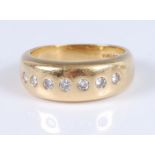 An 18ct yellow gold seven stone diamond Gypsy style dress ring, the round brilliant cut diamonds