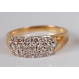 A contemporary 18ct gold diamond dress ring, arranged as three rows of claw set brilliant cut