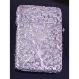 A late 19th century Chinese white metal visiting card case, of hinged rectangular form, profusely