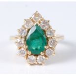 An 18ct yellow gold pear shaped emerald and diamond cluster ring, featuring a centre pear shaped