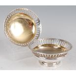 A pair of Edwardian silver bonbon dishes, each having pierced rims and gilt washed bowls, 10.6oz,
