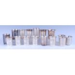 A collection of modern Indian silver and white metal beakers, some with flaring rims and etched