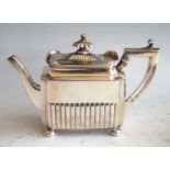A late Victorian silver bachelors teapot, of half-reeded rectangular form, raised on bun feet, 9.