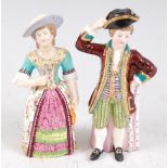 A pair of Victorian Mintons porcelain candle-snuffers, in the form of a boy and a girl from arbours,
