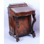 A Victorian figured walnut kneehole writing davenport, having a raised superstructure with hinged