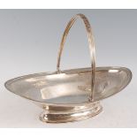 A large George III silver bread basket, of oval form, having swing handle and bright cut