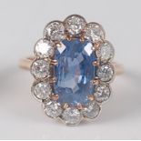 A sapphire and diamond oval cluster ring, claw set in rose metal, sapphire dimensions 12 x 7.25 x