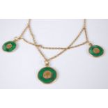 A Chinese yellow metal and jade necklace, supporting three green jade circular pendants, each with