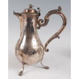 An early 19th century French silver coffee pot, having a hinged dome cover and acanthus C-scroll