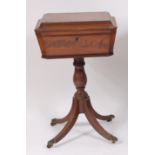 A Regency mahogany pedestal teapoy, the rosewood crossbanded top opening to reveal velvet lined
