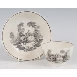 An 18th century porcelain tea bowl on stand, black and white printed with classical courtship