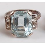 A white metal Art Deco style aquamarine and colourless spinel ring, the trap cut aquamarine