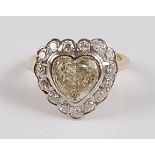 An 18ct yellow and white gold heart shaped diamond cluster ring, comprising a centre heart shaped