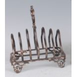 An early Victorian silver six-division toast rack, having loop carry handle and pierced scroll feet,