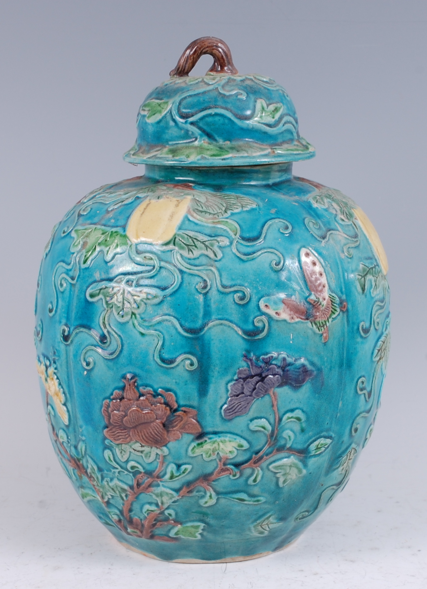 A 19th century Chinese ginger jar and cover, the turquoise ground applied with trailing flowers,