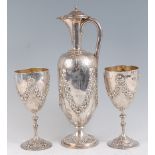 A Victorian silver claret jug or wine ewer, having a hinged dome cover to a slender neck and
