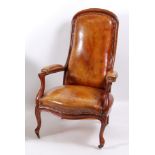 A Victorian mahogany framed and tan leather upholstered armchair, in the French taste, with