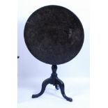 A George III pollard oak pedestal tripod table, having a circular tilt-top with original iron latch,