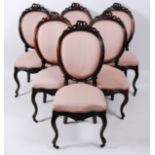 A set of six 19th century French rosewood dining chairs, each having ribbon carved top rail above