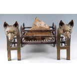 A pair of 19th century brass and wrought iron andirons, having bold fox head terminals, raised on