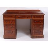 A Victorian mahogany twin pedestal and inverted breakfront kneehole writing desk by Heal & Son of