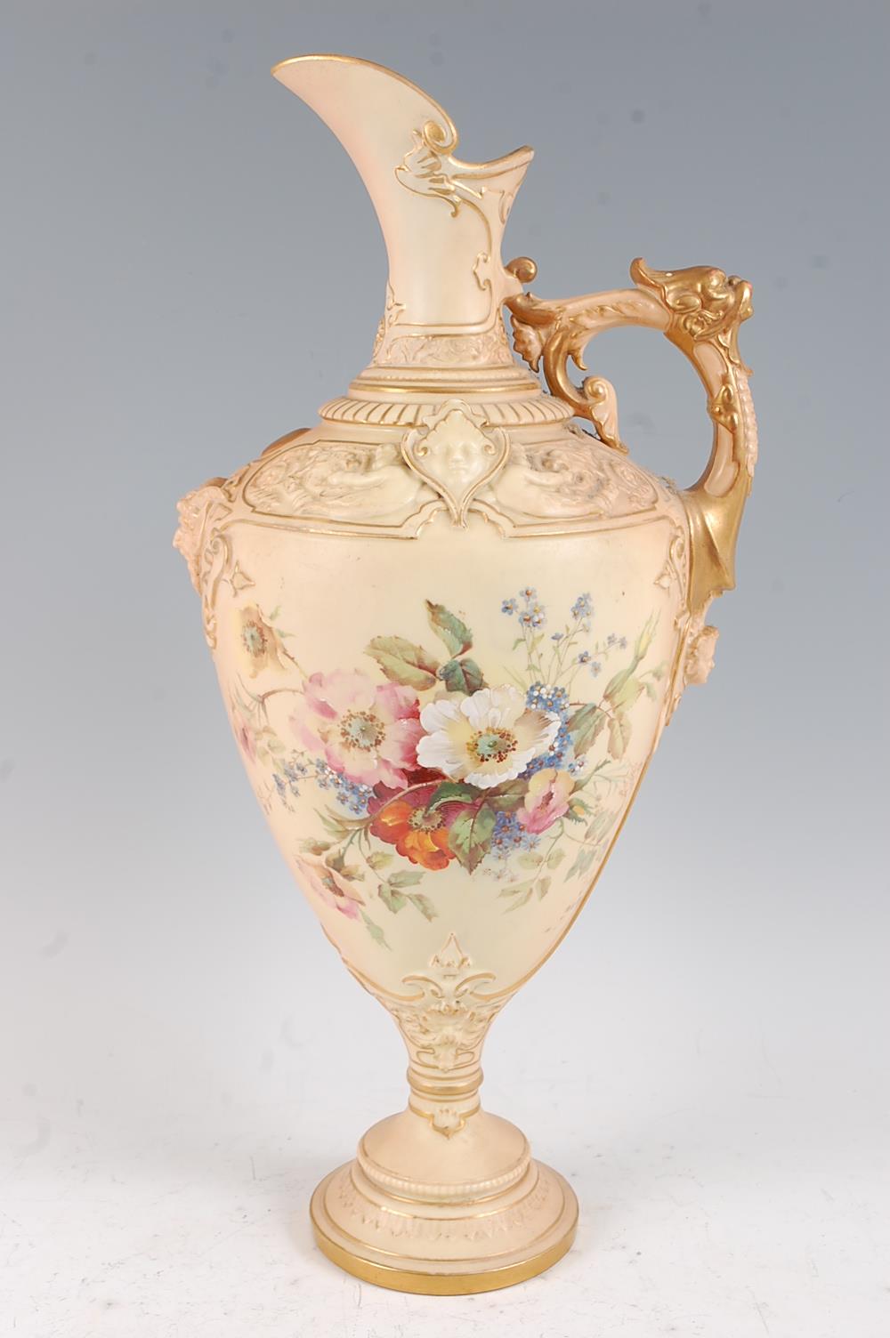 A large Royal Worcester blush ivory ewer, the frieze decorated with cherubs and grotesque masks, the