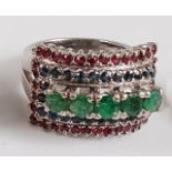 A white metal, emerald, sapphire and ruby rectangular dress ring, comprising five round faceted