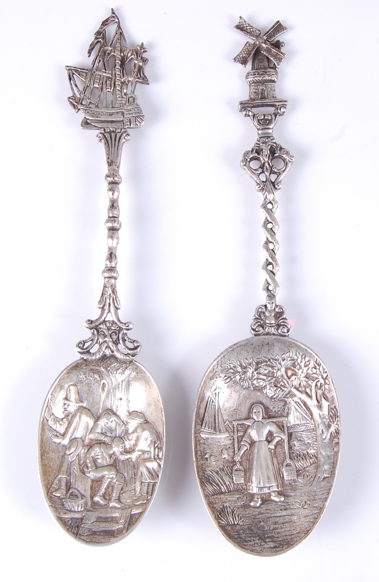 An early 20th century Dutch silver spoon, the bowl repousse decorated with a maid within a river