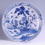 A Chinese export blue and white shallow bowl, decorated with cranes and bamboo within a landscape