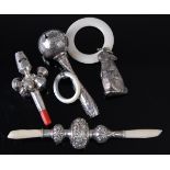A late 19th century continental white metal baby's rattle/whistle, having six bells and bright cut