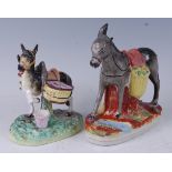 A Victorian Staffordshire table centrepiece in the form of a laden donkey, with foreleg raised, on a
