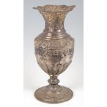 A 19th century continental white metal baluster form vase, the shaped flared rim repousse