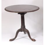 A George III mahogany pedestal tripod table, the one-piece tilt-top having a leaf and ribbon