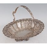 A George V silver basket, of pierced oval form within a beaded rim, having pierced swing handle,