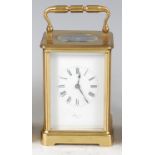 An early 20th century French lacquered brass cased carriage clock, the enamelled dial with Roman