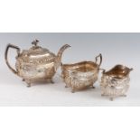 A late Georgian Irish silver three-piece tea set, the teapot with cast floral knop, the body with