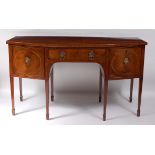 A Regency period mahogany bowfront sideboard, having two drawers and cupboard doors, one as a fitted