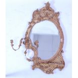 A 19th century giltwood and gesso girandole, the shaped and bevelled mirrorplate within a swept