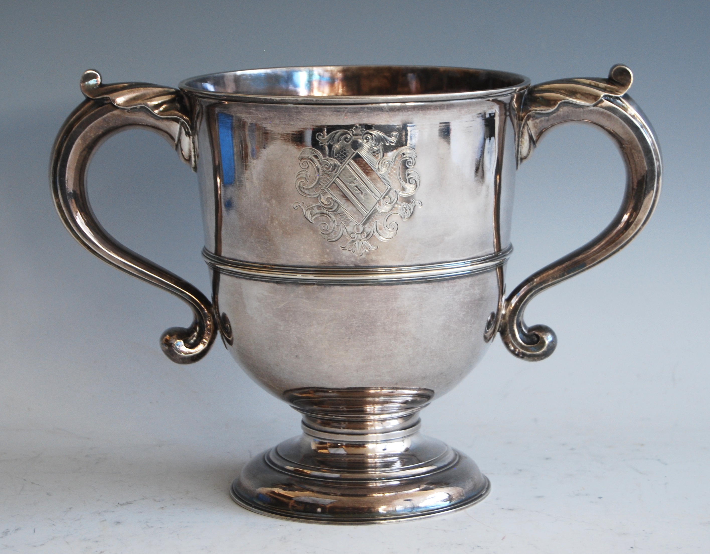 A George II silver twin handled loving cup, having twin bright cut engraved armorials, the S