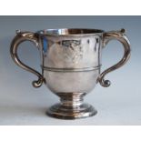 A George II silver twin handled loving cup, having twin bright cut engraved armorials, the S